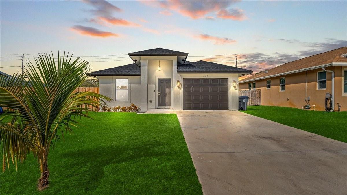 A single-story house with a white exterior, a brown garage door, and a concrete driveway — 4317 Vicliff Road, West Palm Beach FL 33406, WEST PALM BEACH, FL