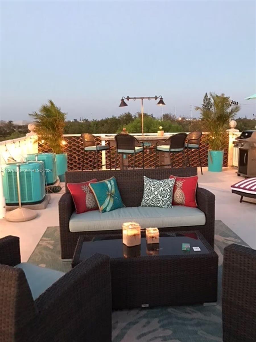 A rooftop patio features wicker furniture, a coffee table, and a bar area with stools — 12400 Overseas Hwy, Marathon FL 33050, MARATHON, FL