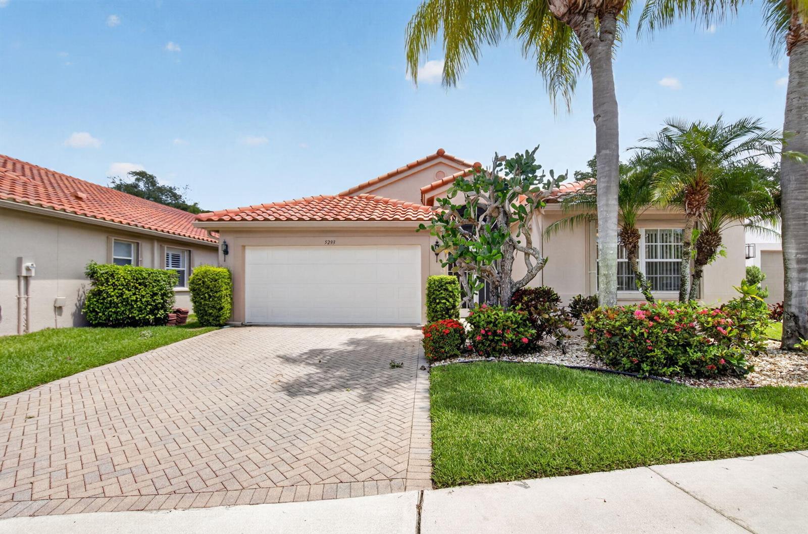 A single-story house with a tiled roof, a paved driveway, and a two-car garage — 5293 Grey Birch Lane, Boynton Beach FL 33437, BOYNTON BEACH, FL