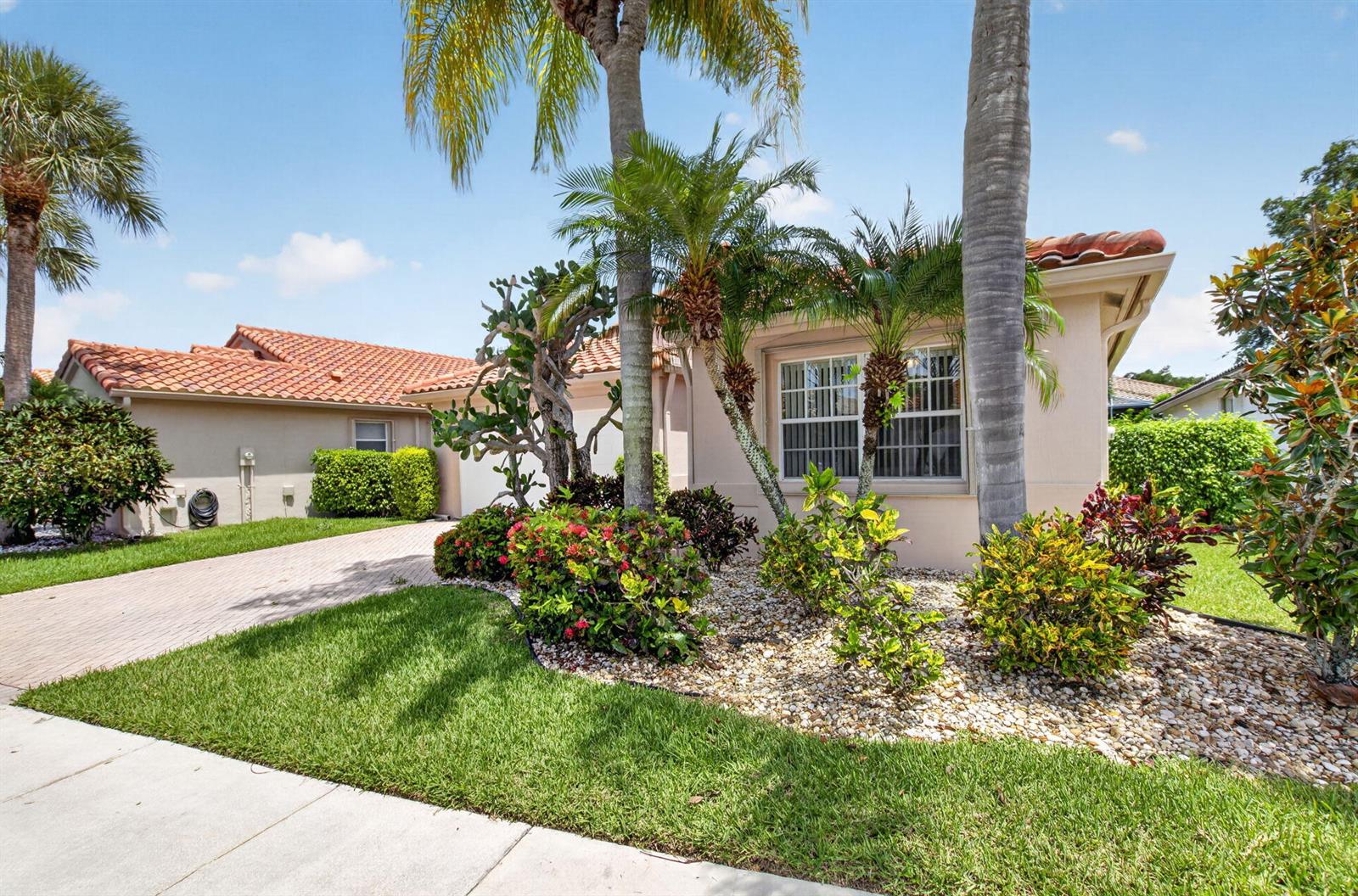 A single-story house with a tile roof, palm trees, and a landscaped front yard — 5293 Grey Birch Lane, Boynton Beach FL 33437, BOYNTON BEACH, FL