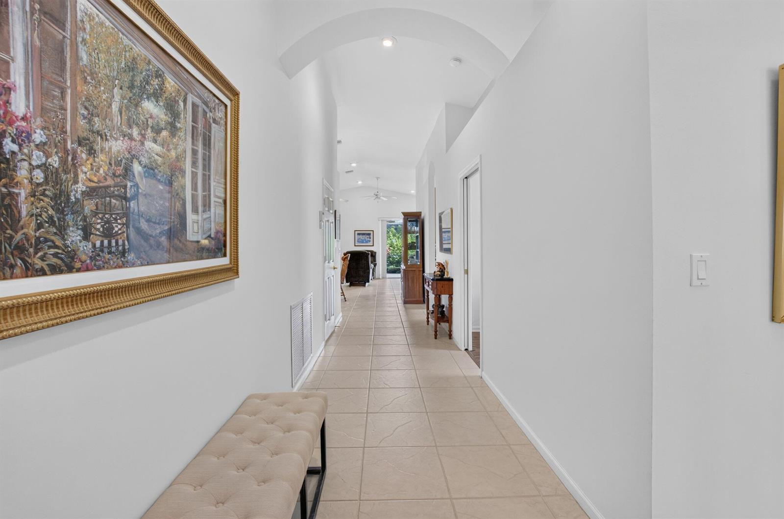 A long hallway with tiled floors, an arched ceiling, and a large framed wall painting — 5293 Grey Birch Lane, Boynton Beach FL 33437, BOYNTON BEACH, FL