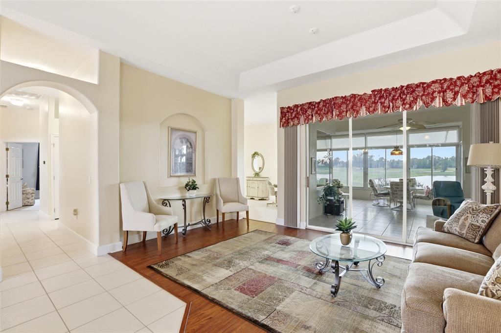A living room features tile and wood flooring, a glass coffee table, and sliding glass doors — 237 GOLF VISTA DRIVE, DAVENPORT, FL