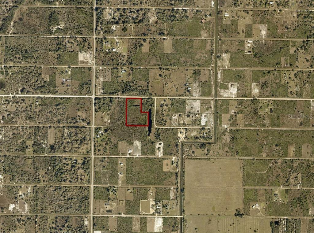 An aerial map view shows a vacant, rectangular lot outlined in red — 18924 NW 272ND STREET, OKEECHOBEE, FL