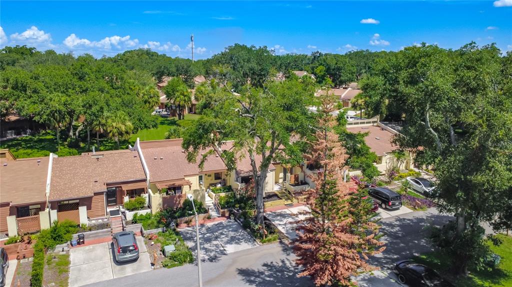 An aerial view shows a row of townhouses with brown roofs and driveways — 712 TEAL LANE, ALTAMONTE SPRINGS, FL