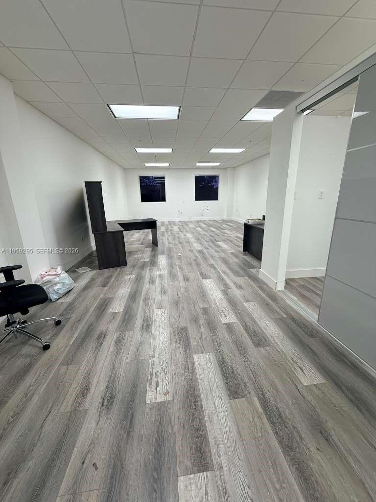 An office space features gray wood-look flooring, white walls, and a drop ceiling — 7791 NW 46th St # 201, Doral FL 33166, DORAL, FL