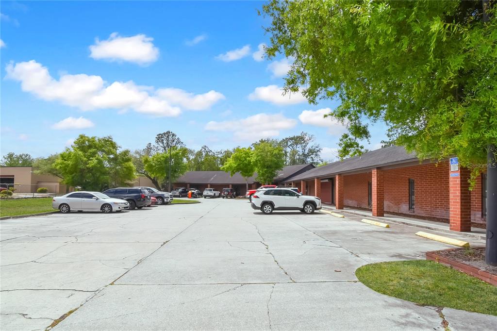 A parking lot sits in front of a single-story brick commercial building with a walkway — 1840 DUNN AVENUE UNIT 6, JACKSONVILLE, FL