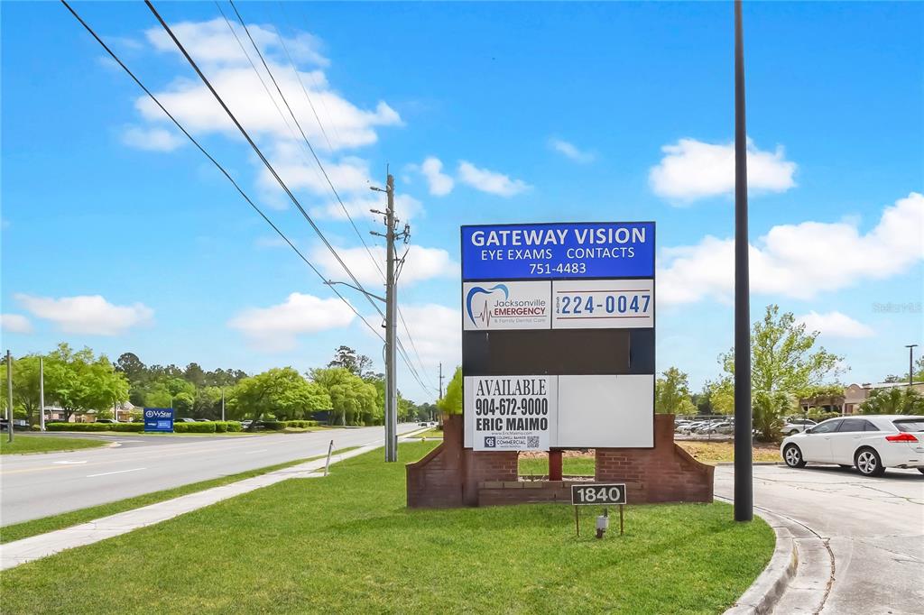 A multi-tenant commercial sign stands on a grassy lawn beside a road — 1840 DUNN AVENUE UNIT 6, JACKSONVILLE, FL