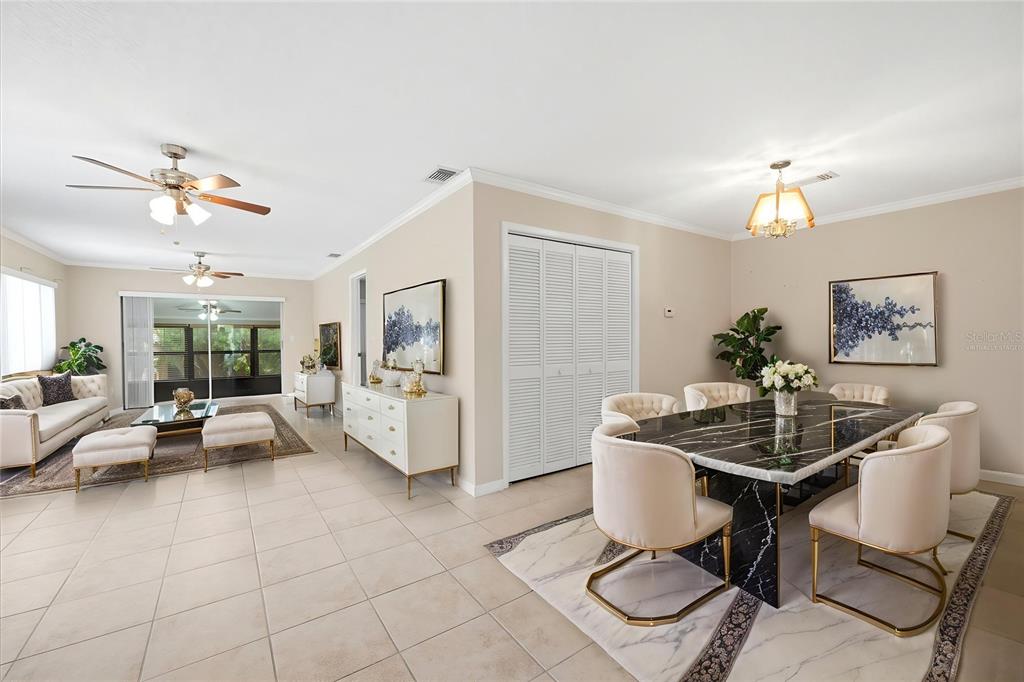 A dining area with a marble table and a living room with tile floors — 3820 LIGHTHOUSE WAY, NEW PORT RICHEY, FL