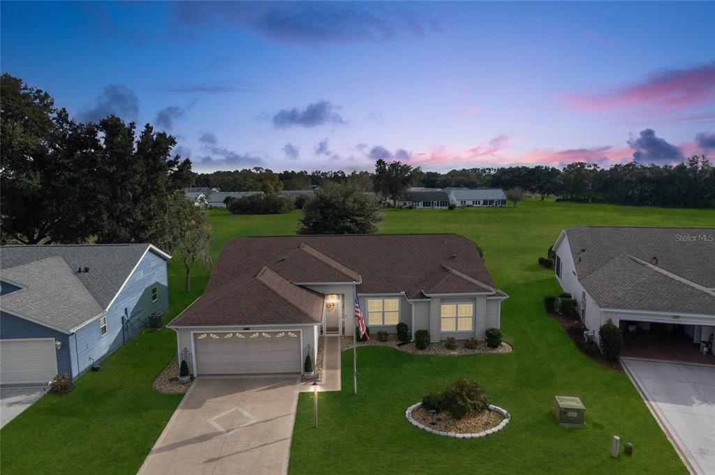 An aerial view of a single-story suburban house with a tan exterior and lawn — 25233 LOST OAK CIRCLE, LEESBURG, FL
