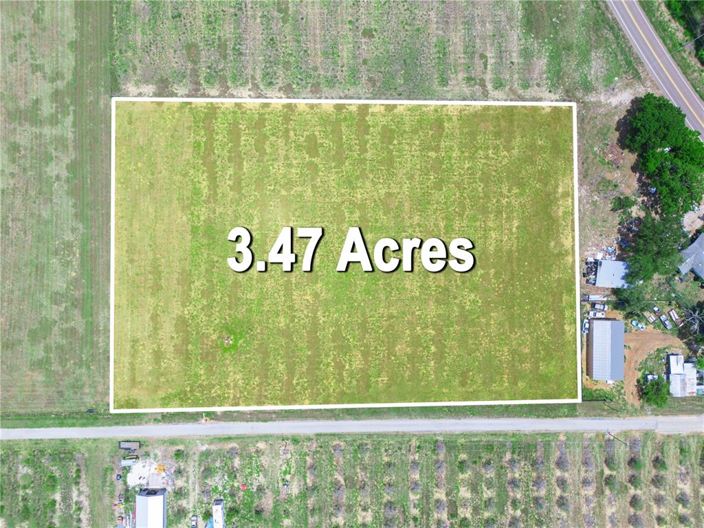 An aerial view shows a rectangular 3.47-acre plot of land bordered by roads — 0 FLOOD ROAD, FROSTPROOF, FL