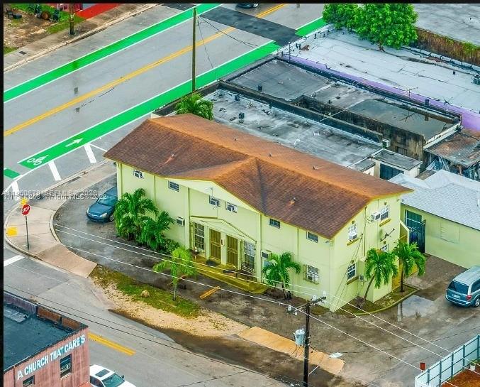 An aerial view shows a two-story yellow apartment building with a brown roof — 1500 NW 69th Ter, Miami FL 33147, MIAMI, FL