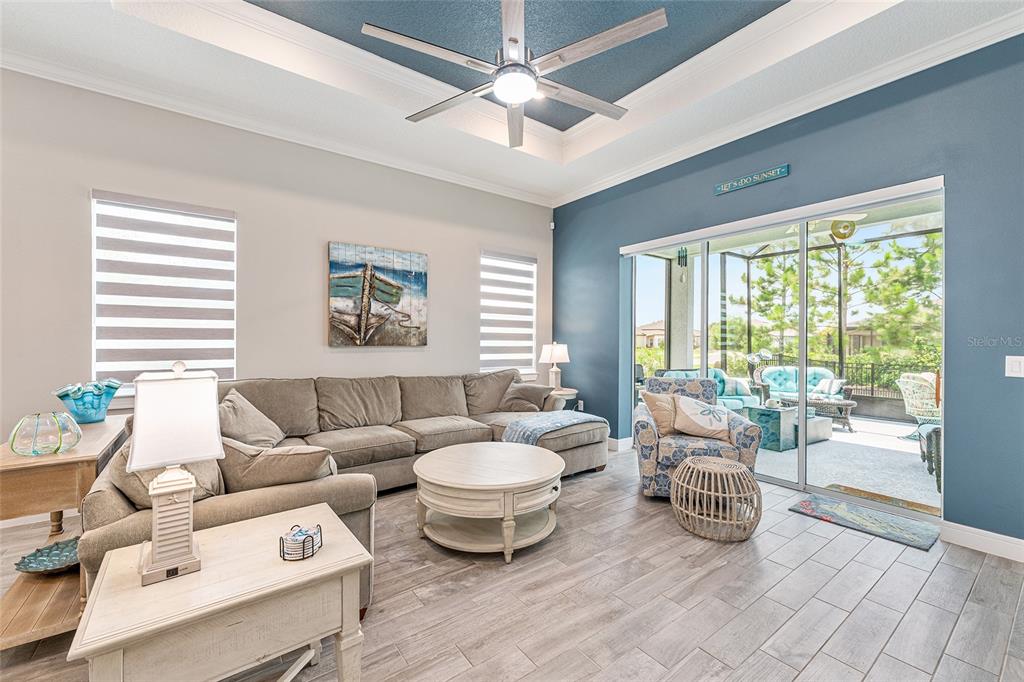 A living room features a sectional sofa, a coffee table, and sliding doors to a patio — 8876 SW 59TH LANE ROAD, OCALA, FL
