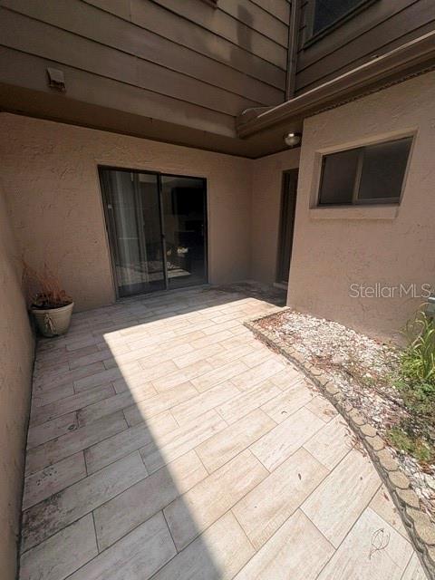 A paved patio area features a sliding glass door and a small window — 459 MEADOWOOD BOULEVARD, FERN PARK, FL
