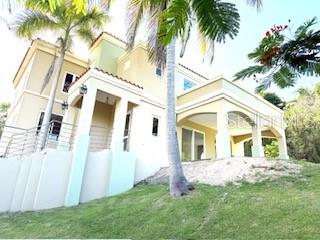 A multi-story house with a beige exterior, a covered patio, and palm trees on a lawn — 56 HARBOUR LIGHTS ESTATES EXTENSION UNIT 56, HUMACAO, PR