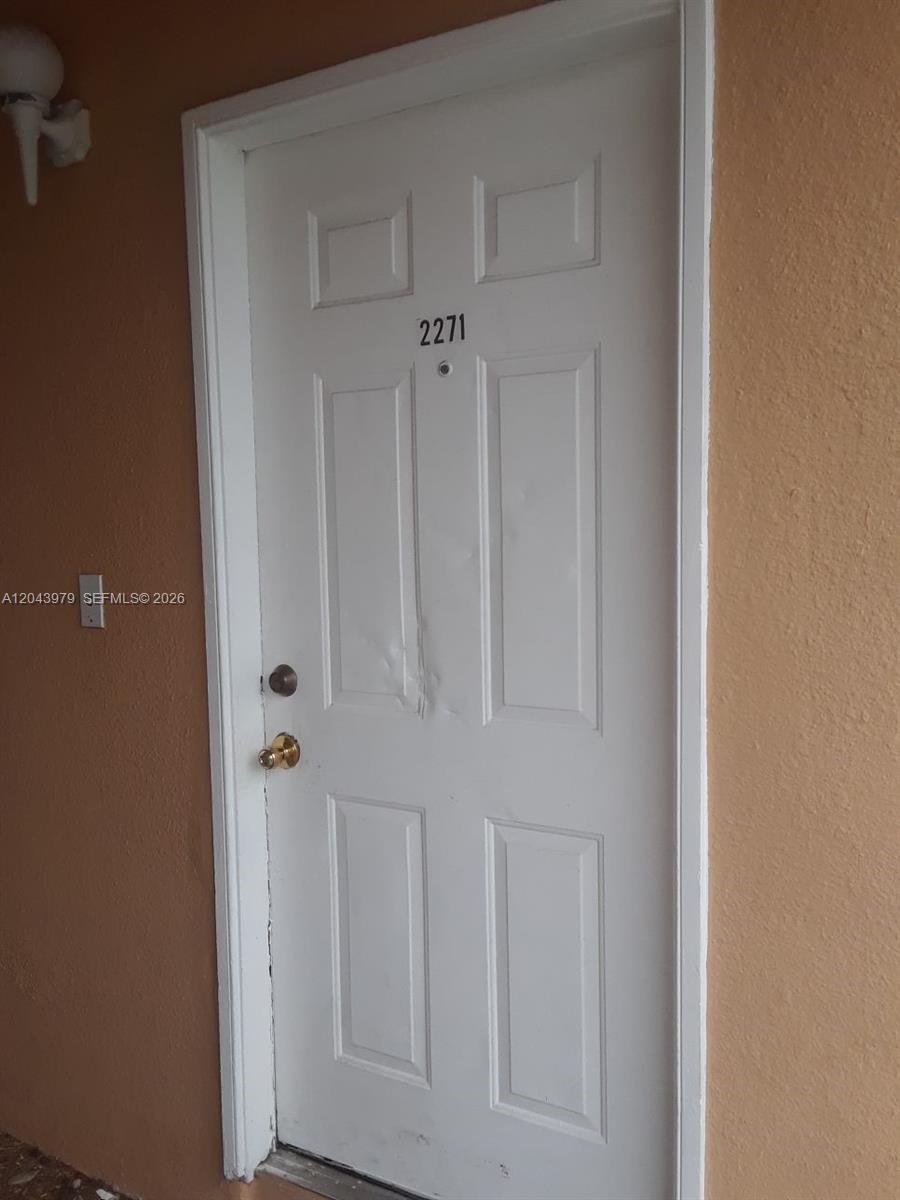 A white six-panel door with the number 2271 is set into a tan exterior wall — 2271 SW 80th Ter # 2271, Miramar FL 33025, MIRAMAR, FL