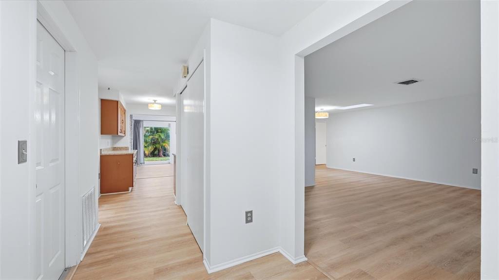 A view from a hallway looking into a kitchen and a large living area — 1329 NANTUCKET ROAD, VENICE, FL