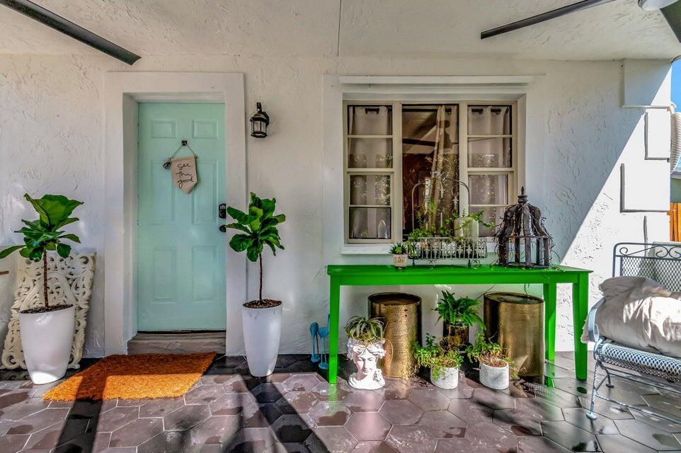 A covered porch features a light blue front door, a green console table, and potted plants — 237 SW 3rd Avenue, Delray Beach FL 33444, DELRAY BEACH, FL