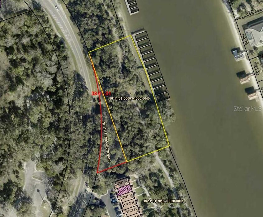 An aerial map shows a wooded waterfront parcel with a dock and adjacent residential units — 60 PALM HARBOR PARKWAY, PALM COAST, FL