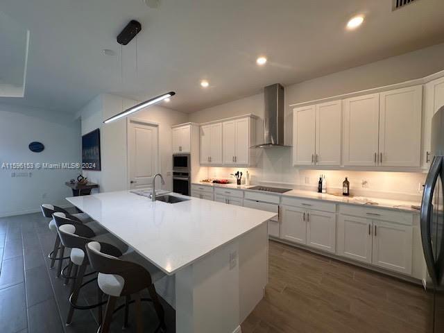A modern kitchen features white cabinetry, a large quartz island, and stainless steel appliances — 5545 Hampton Links Ct # 5545, Ave Maria FL 34142, AVE MARIA, FL
