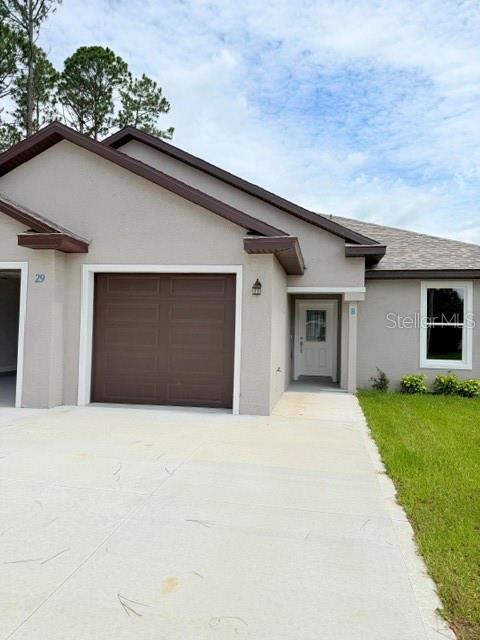 A single-story house exterior features a brown garage door, a white front door, and siding — 29 SLUMBER PATH UNIT B, PALM COAST, FL