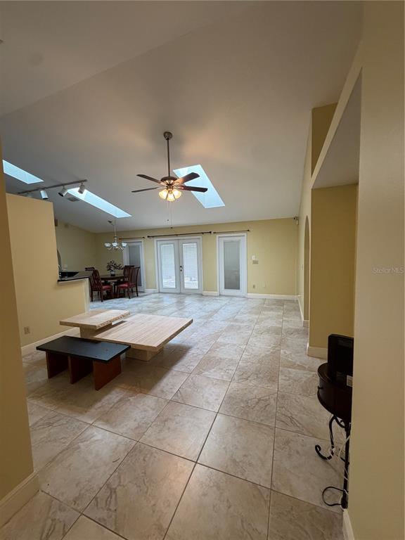 A spacious living area features vaulted ceilings, skylights, tile flooring, and a dining nook — 2243 BANCROFT BOULEVARD, ORLANDO, FL