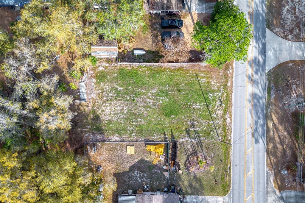 An aerial view shows a vacant rectangular lot situated between two residential properties and a road — LAKE GRIFFIN ROAD, LADY LAKE, FL