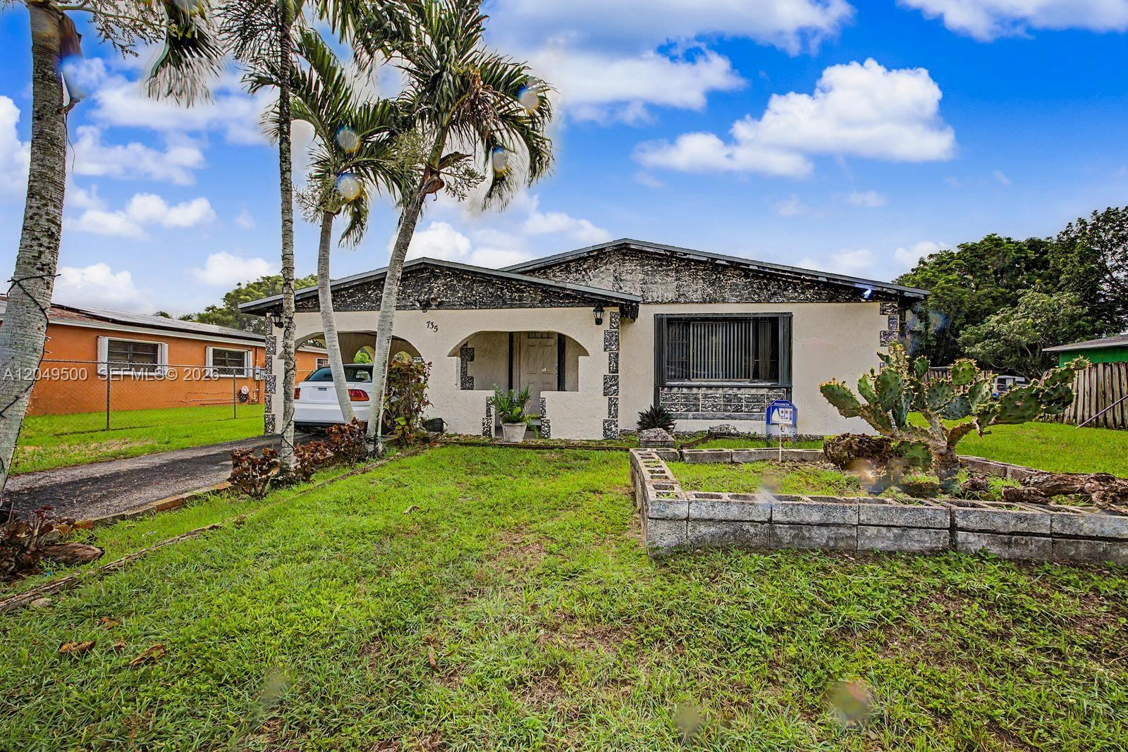 A single-story house with a stucco exterior, a front porch, and a cactus garden — 735 NW 8th Ct, Florida City FL 33034, FLORIDA CITY, FL