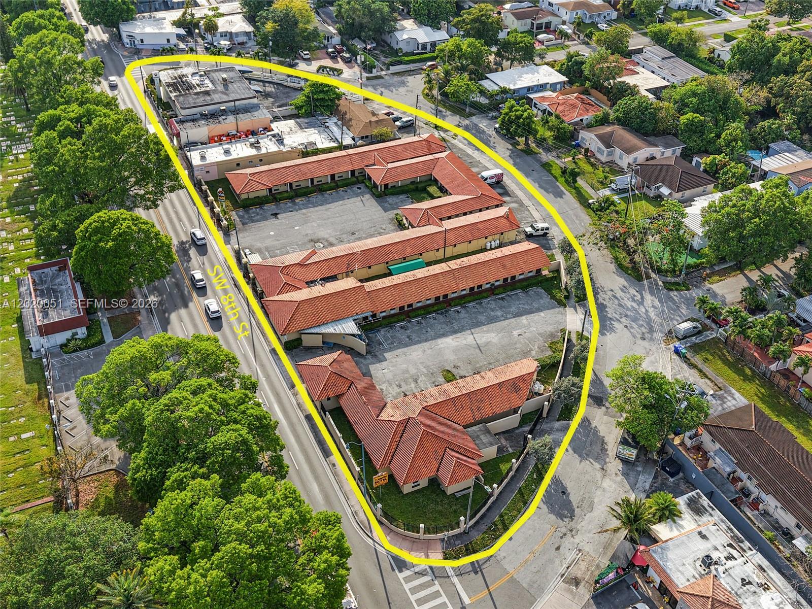 An aerial view shows a U-shaped motel complex with a red tile roof and parking — 4445 SW 8th St, Miami FL 33134, MIAMI, FL
