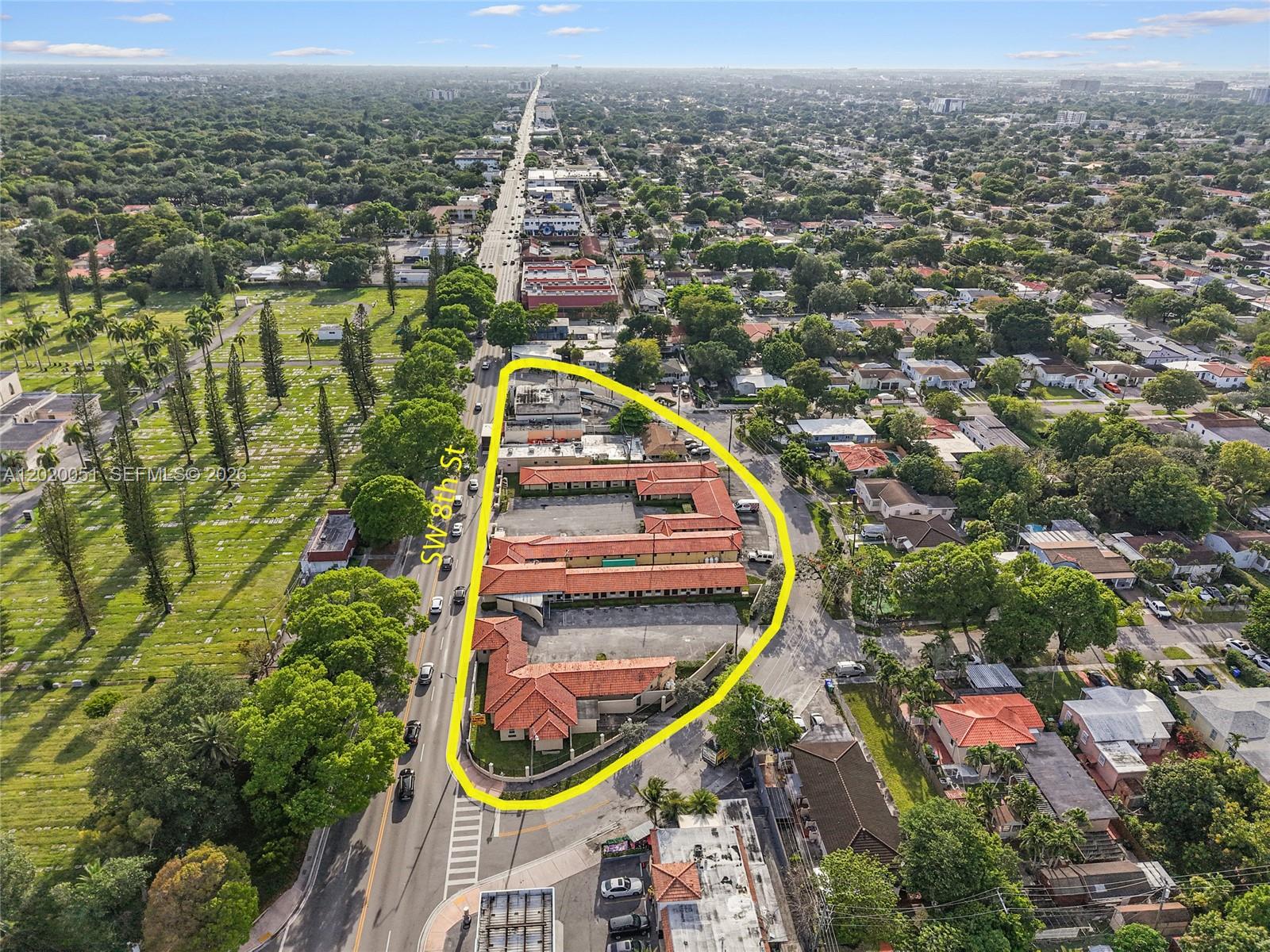 An aerial view shows a commercial property with red-tiled roofs situated on a triangular lot — 4445 SW 8th St, Miami FL 33134, MIAMI, FL