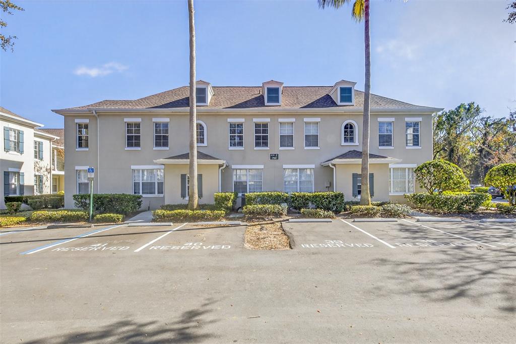 A two-story apartment building with reserved parking spaces in front and palm trees — 760 SIENA PALM DRIVE UNIT 204, CELEBRATION, FL