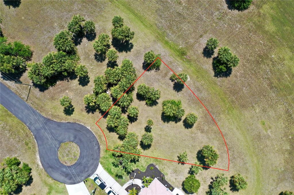 An aerial view shows a residential lot outlined in red next to a cul-de-sac — 16091 CHITLAN COURT, PUNTA GORDA, FL