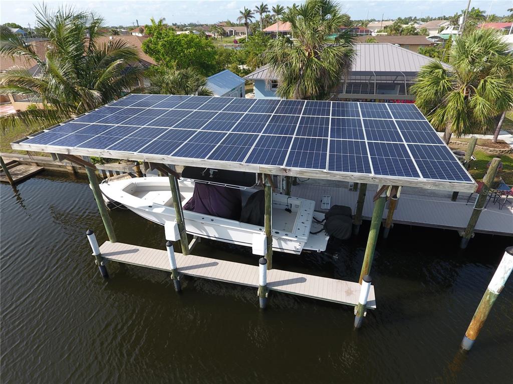 An aerial view of a boat lift covered by a large solar panel array — 107 SINCLAIR STREET SE, PORT CHARLOTTE, FL