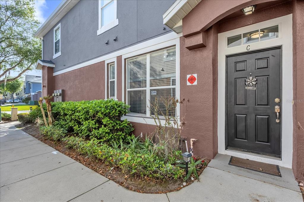A brown and gray exterior wall features a black front door labeled with a C — 6452 S GOLDENROD ROAD UNIT 26C, ORLANDO, FL
