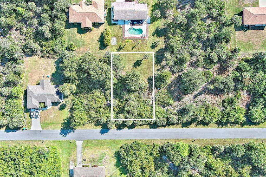 An aerial view shows a rectangular vacant lot outlined in white between two residential properties — 6184 LOMAX STREET, ENGLEWOOD, FL