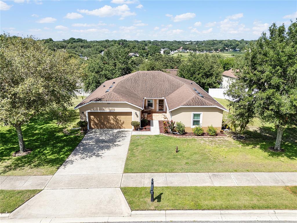 An aerial view of a single-story house with a brown roof and a concrete driveway — 2388 YELLOW GRASS COURT, APOPKA, FL