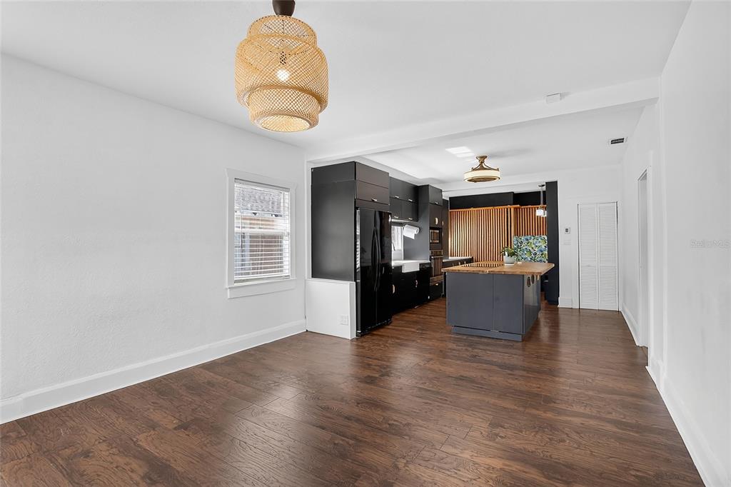 A kitchen and dining area with dark cabinetry, a wood-topped island, and hardwood floors — 212 W GENESEE STREET, TAMPA, FL