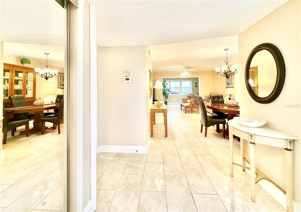 A tiled entryway leads into a dining room and living area with neutral walls — 1247 S MARTIN LUTHER KING JUNIOR AVENUE UNIT D103, CLEARWATER, FL
