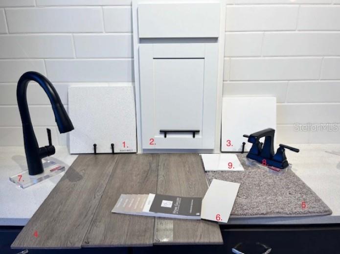 A selection of interior design samples including cabinet, countertop, flooring, and faucet finishes — 14511 BANKS COURT, PARRISH, FL