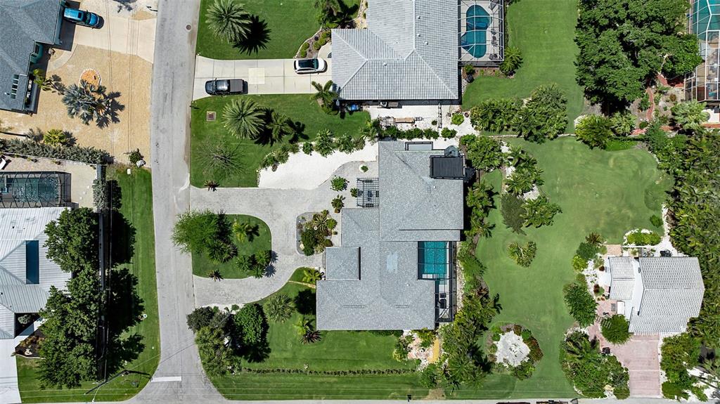 An aerial view shows a residential property with multiple houses, swimming pools, and landscaped yards — 608 GARDENIA DRIVE, VENICE, FL
