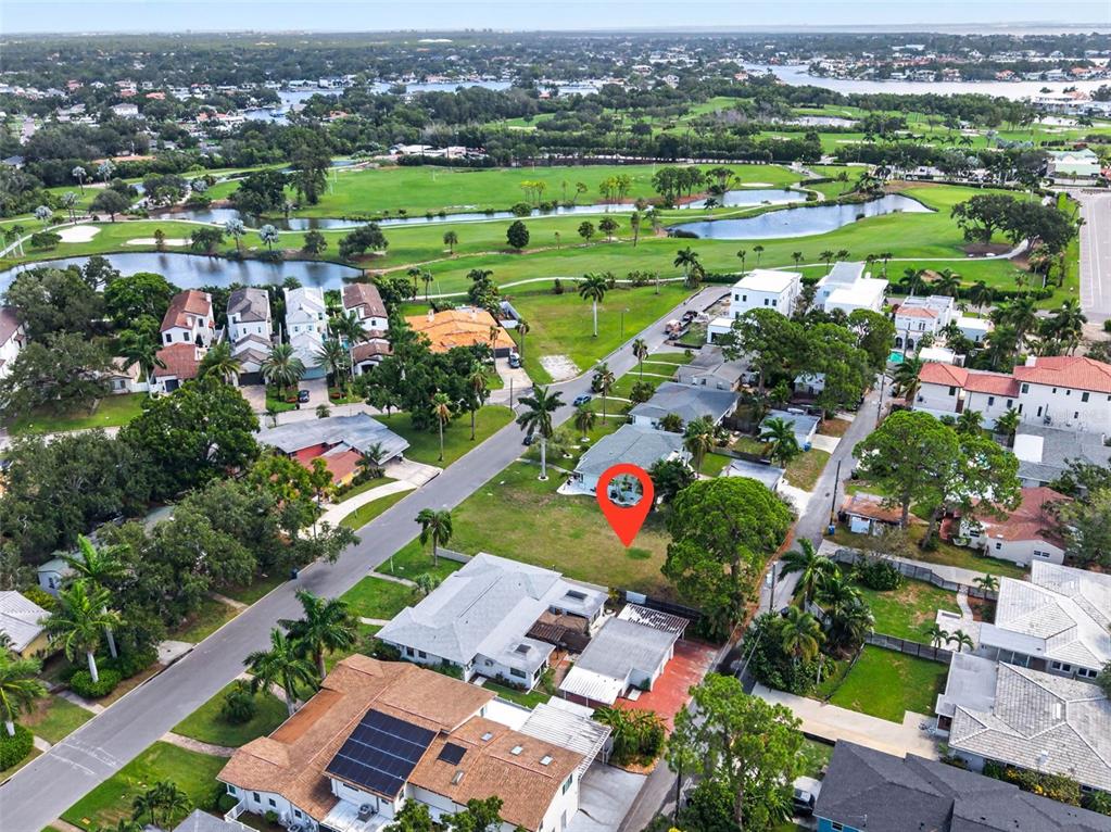 An aerial view shows a vacant residential lot marked with a red pin — 257 MATEO WAY NE, ST PETERSBURG, FL