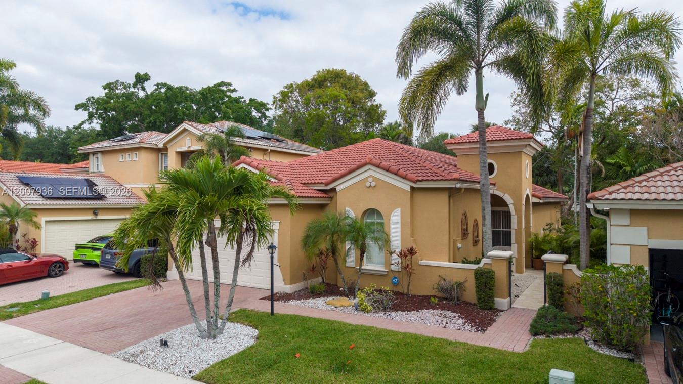 A tan, single-story house with a red tile roof and a paved driveway — 12159 NW 59th St, Coral Springs FL 33076, CORAL SPRINGS, FL