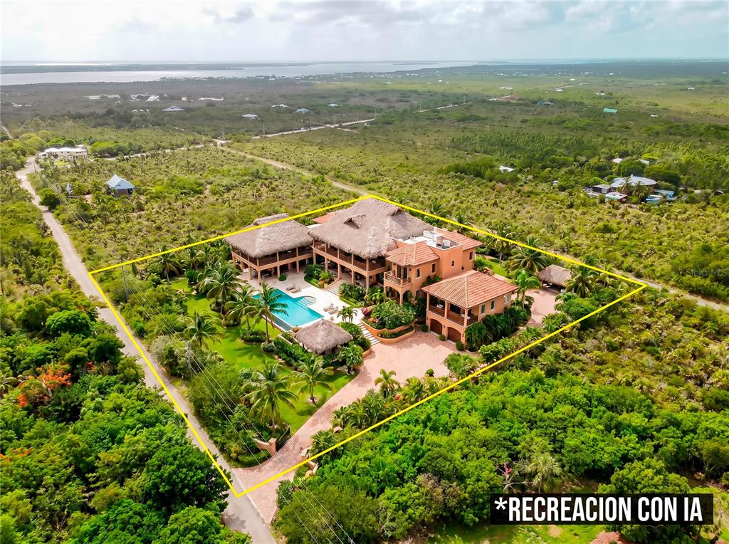 An aerial view shows a large multi-story villa with a thatched roof and swimming pool — RACOON RUN, BIG PINE KEY, FL