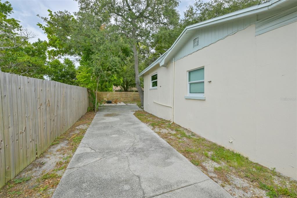 A kitchen features white cabinets, black countertops, stainless steel appliances, and a central island — 7031 WOODCHASE GLEN DRIVE, RIVERVIEW, FL