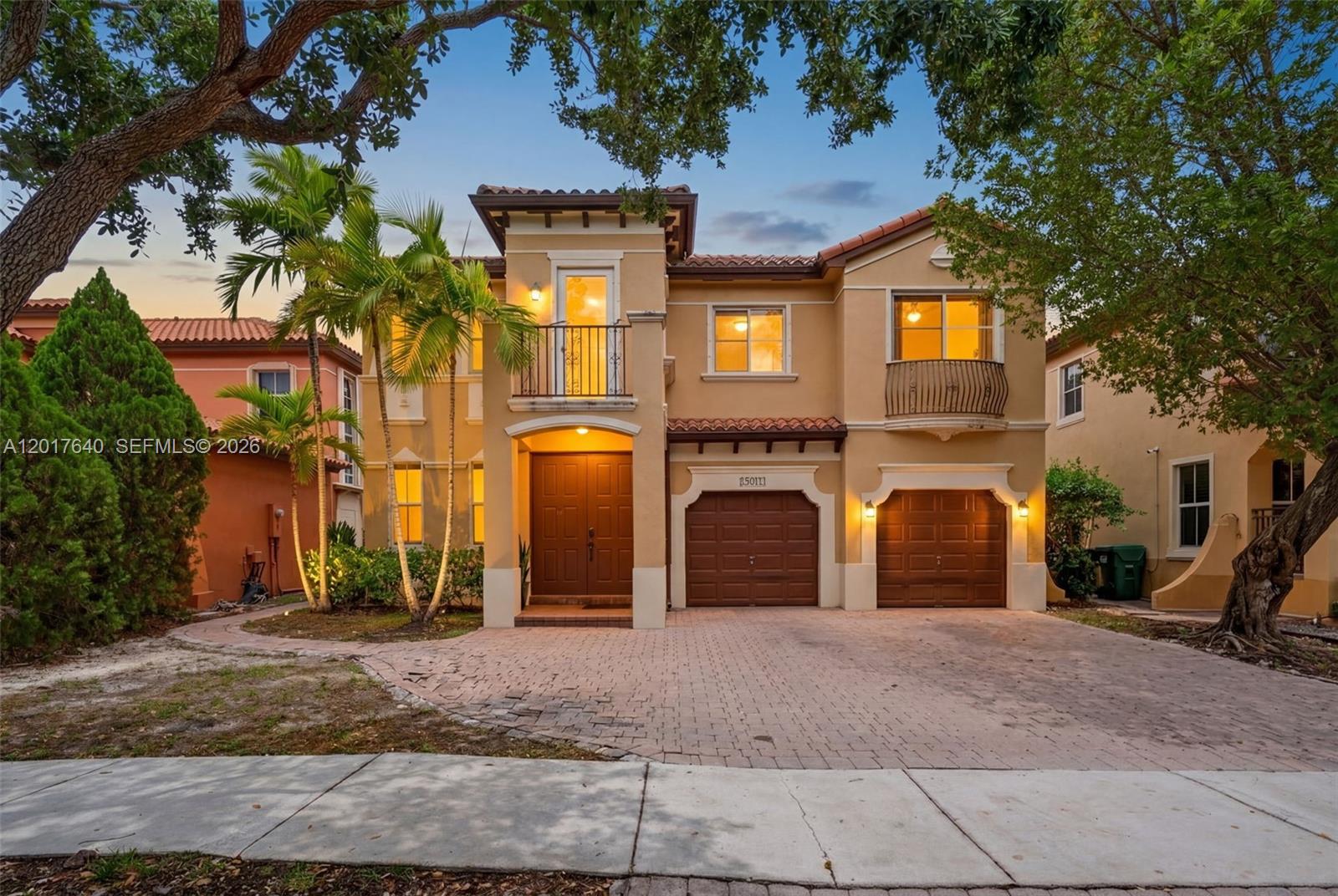 A two-story Mediterranean-style house features a double garage, a balcony, and a paved driveway — 2631 SW 153rd Path, Miami FL 33185, MIAMI, FL