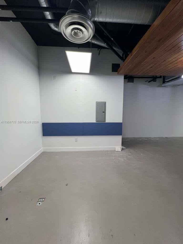 An interior room features a gray concrete floor, white walls, and an exposed ceiling — 20200 W Dixie Hwy # 1008, Miami FL 33180, MIAMI, FL
