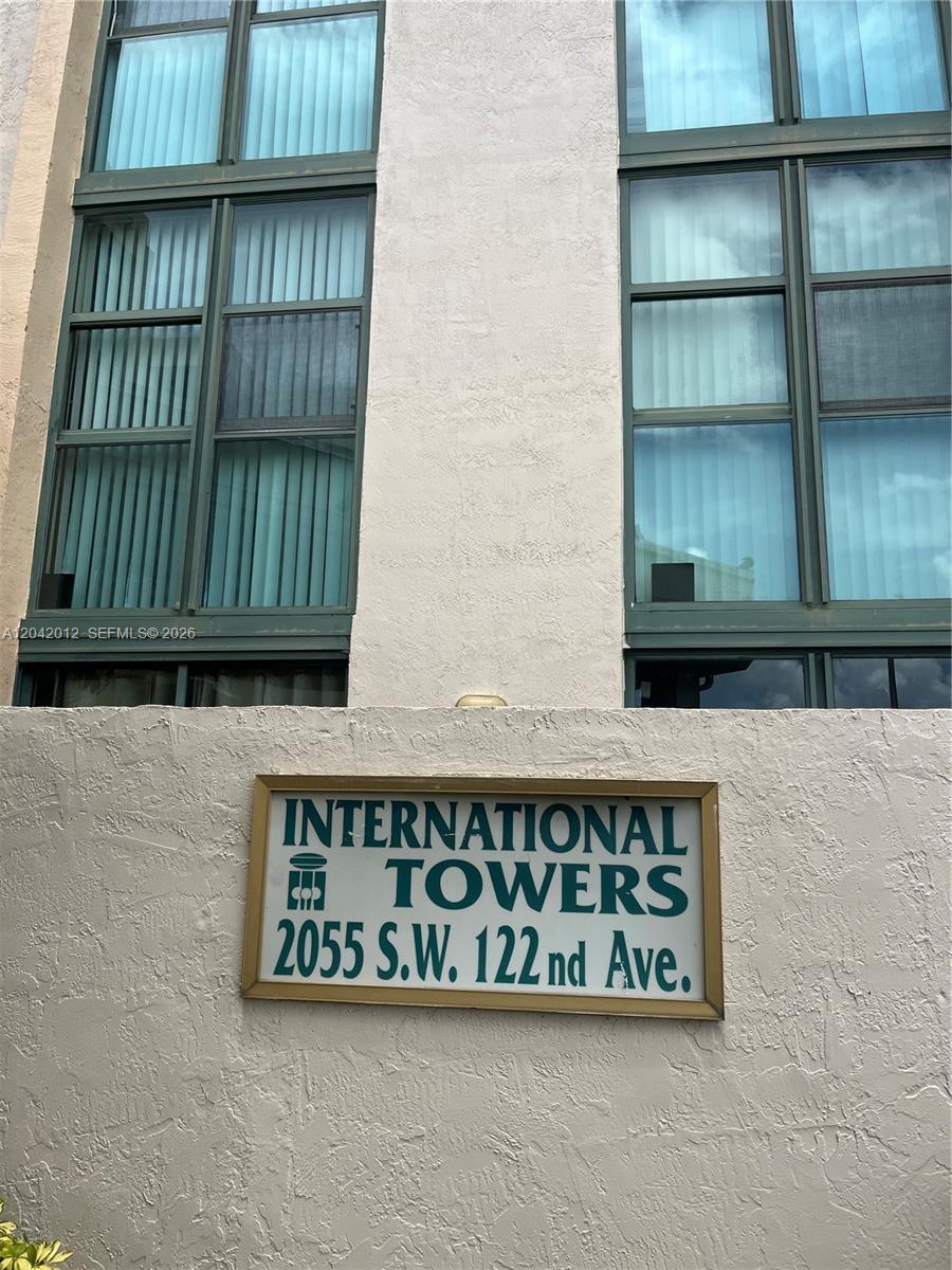 The exterior of a building features large windows and a sign identifying International Towers — 2055 SW 122nd Ave # 321, Miami FL 33175, MIAMI, FL