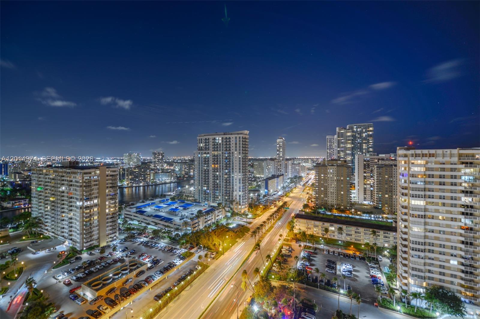 An elevated night view shows a city street, parking lots, and several high-rise apartment buildings — 1980 S Ocean Dr, Hallandale Beach FL 33009, HALLANDALE BEACH, FL