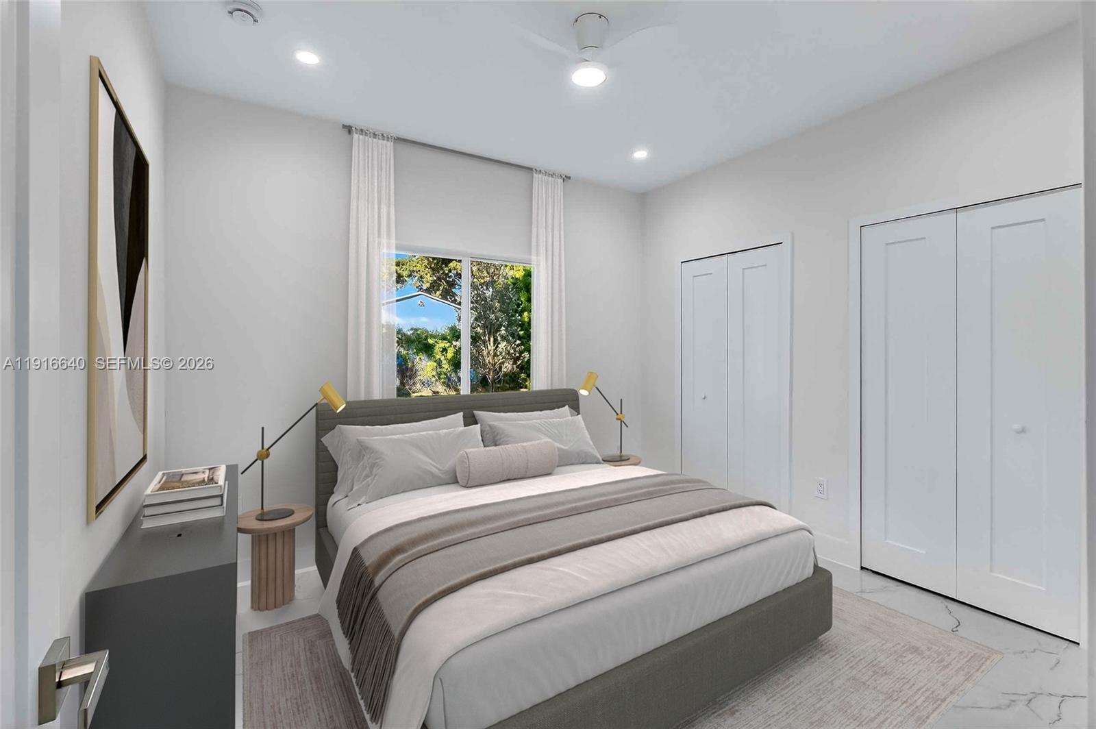A bedroom features a gray upholstered bed, white walls, two closets, and a window — 1346 NW 44th St, Miami FL 33142, MIAMI, FL