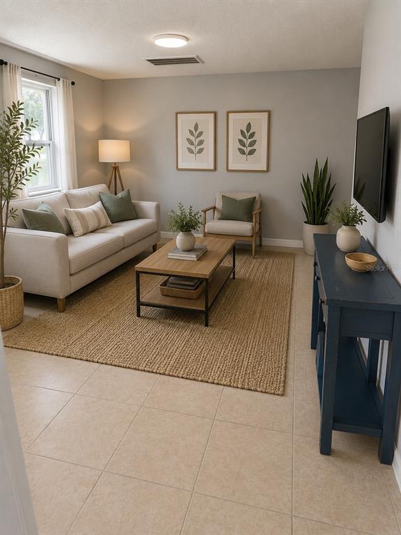 A living room features a beige sofa, a wooden coffee table, and a blue console table — 7325 IVANHOE DRIVE, PORT RICHEY, FL