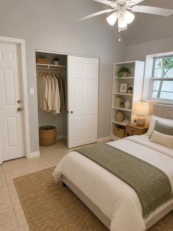 A bedroom features a bed, a closet, a bookshelf, and a ceiling fan — 7325 IVANHOE DRIVE, PORT RICHEY, FL